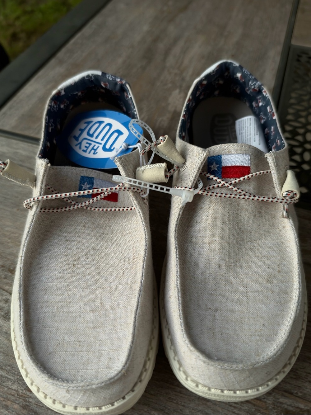 Hey Dude Women’s  Slip-On Moccasins in Natural Linen with Texas Flag Detail
